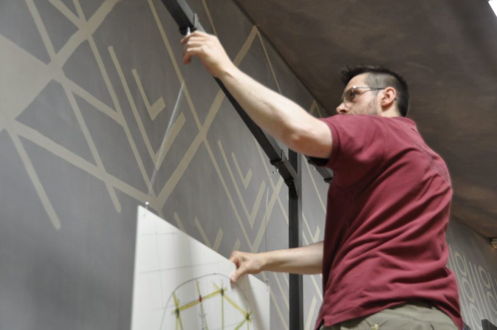 Haustechniker Siegmar Gamper beim Hängen der Ausstellung Ein Haus wie damals im archeoParc Schnalstal<br/> Allestimento in corso: La mostra La casa di Ötzi. La ricostruzione di una capanna preistorica curata da Johanna Niederkofler presso larcheoParc della val Senales <br/>Working for the exhibition on a Cupper Age house reconstruction and its building materials still used in creating modern environmentally sustainable buildings designed by Johanna Niederkofler at archeoParc Val Senales July-November 2016