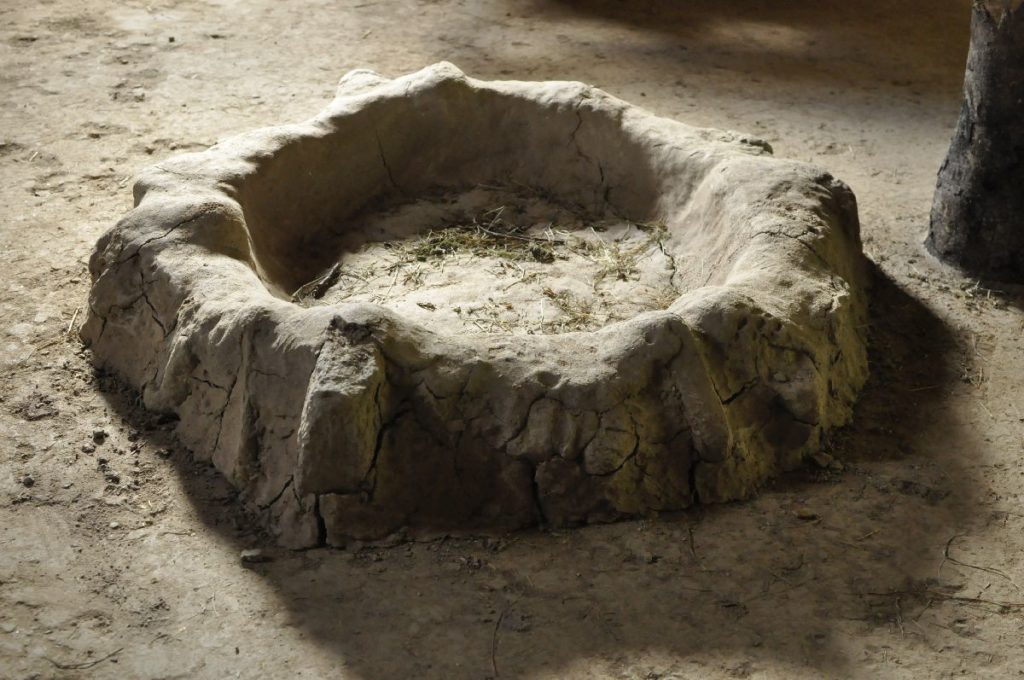 Feuerstelle aus Lehm im Steinzeithaus Villanders-Plunacker<br/>Focolare in creta nella casa Villanders-Plunacker<br/>Fireplace in the house Villanders-Plunacker
